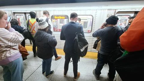 Crowded TTC subway platform with a broken-down train Stock Photos