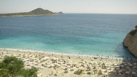 Crowded Turkish Beach with Turquoise Sea, White Beach Umbrellas and Island View Видео 346105304