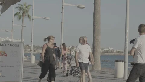 A crowded walk along the beach in Paphos, Cyprus Stock Footage 344056566
