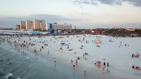 Crowded White Sand Beach and Pier Drone Shot at Sunset Stock Footage 88414891
