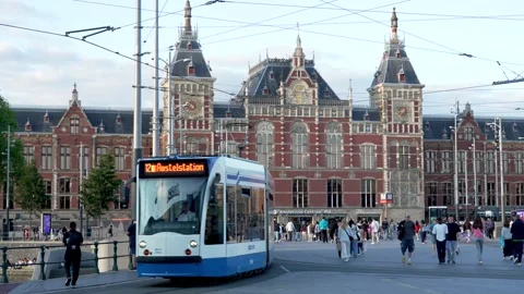 Crowds and Traffic in Front of Historic Amsterdam Central Train Station Stock Footage 313676280
