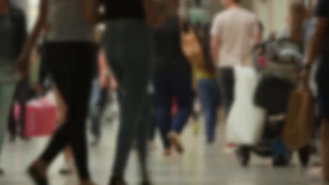 Crowds of anonymous shoppers walking in a busy mall carrying shopping bags Video stock 89774676