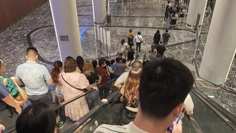 Crowds are leaving a venue using escalators Stock Footage 274855700
