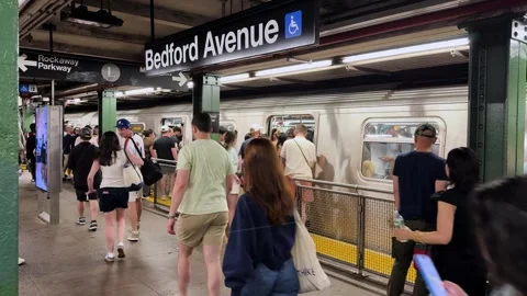 Crowds Board and Exit L Train at Bedford Avenue Subway Station in New York City Stock Footage 337910049