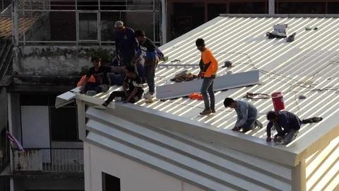 Crowds of construction worker installing aluminum roof Stock Footage 78016127