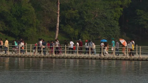 Crowds crossing the temporary floating bridge to Angkor Wat [2023] Stock Footage 238365584