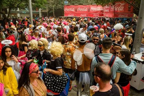 Crowds of dressed up people party in the streets during the Daytime Carniv... Stock Photos