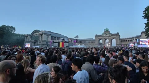 Crowds fill the park in front of the Cinquantenaire Arch for the open air Stock Footage 341074202