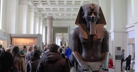 Crowds gather around colossal statue of Pharaoh Ramesses II at British Museum Stock Footage 321020284