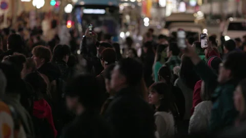 Crowds gathered at Shibuya scramble crossing film with their phones (editorial) Video stock 295207341