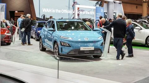 Crowds looking at new car models at Auto show. Hyundai Kona electric car on d Stock Photos