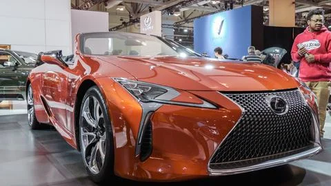 Crowds looking at new car models at Auto show. Lexus car on display. Nation.. Stock Photos