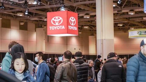 Crowds looking at new car models at Auto show. New car on display. National.. Stock Photos