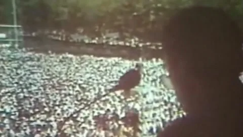 Crowds marching through city streets during Iranian Revolution events 스톡 동영상 325857895