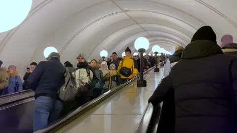 Crowds Navigate Escalator in a Busy Underground Station During Evening Rush Hour Stock Footage 314280713