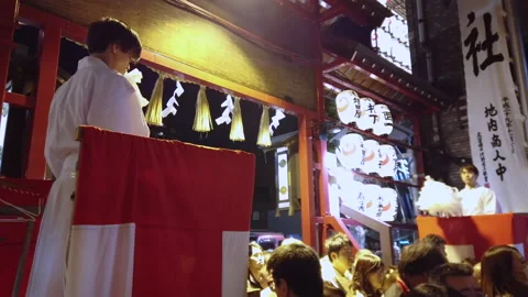 Crowds passing through the torii gate of Ootori shrine during Tori-no-Ichi Fair. Stock Footage 143617164