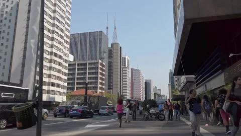 Crowds of pedestrians navigate the bustling streets of sao paulo, brazil Stock Footage 297287090