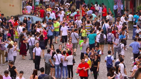CROWDS OF PEOPLE ON COBBLED R DE SAO PAULO MACAU Stock Footage 67017367