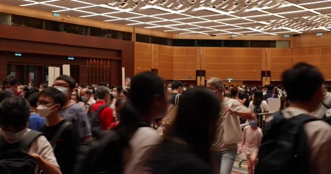 Crowds of People with face masks wait in queue to buy books in Hon Stock Footage 158096124