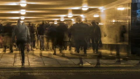 Crowds of people moving through the underpass Stock Footage 98589424