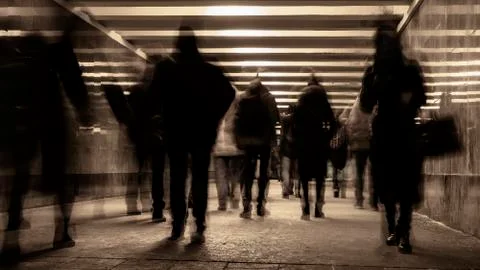 Crowds of people moving through the underpass Stock Photos