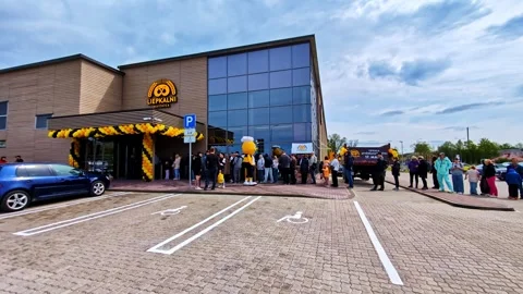Crowds of people queuing outside a modern Liepkalni bakery building during a Stock Footage 341457634