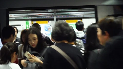 Crowds of people waiting to enter underground subway train - Gimbal stabilized Stock Footage 92048122