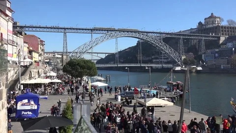 Crowds of people walking Cais Da Ribeira, and Dom Luis Bridge Porto, Portugal Stock Footage 71145283