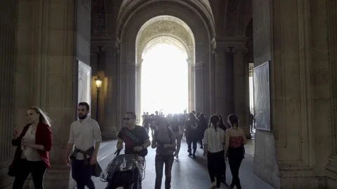 Crowds of people walking through corridor at Le Louvre museum - outside - Paris Stock Footage 94060479