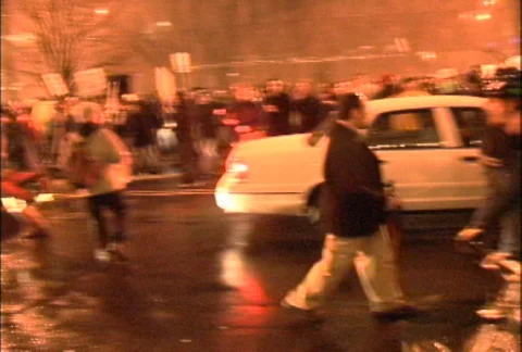 Crowds of Protesters Marching Down Street at Night at WTO Protests Stock Footage 106957294