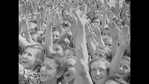 Crowds rush forward, young men march German flags past Hitler Stock Footage 103376360