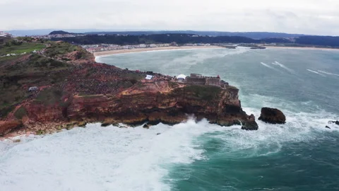 Crowds of spectators enjoying Atlantic ocean waves crashing over rocky coast dur 스톡 동영상 328952592