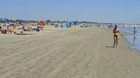 Crowds of sun bathers line Sullivan Beach, SC Stock Footage 335238532