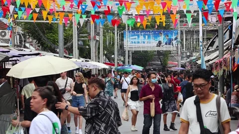 Crowds of Thai and foreign shoppers enjoy hanging out at Chatuchak Market. Stock Footage 278328518