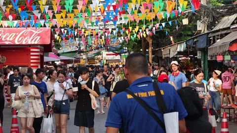 Crowds of Thai and foreign shoppers enjoy hanging out at Chatuchak Market. Stock Footage 280363135