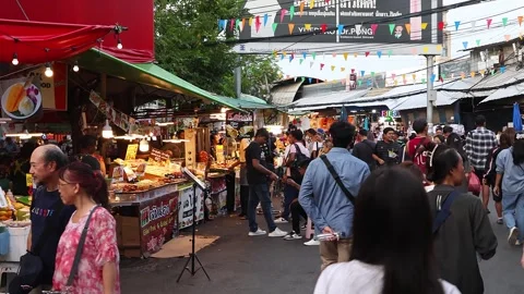 Crowds of Thai and foreign shoppers enjoy hanging out at Chatuchak Market. Stock Footage 280363186