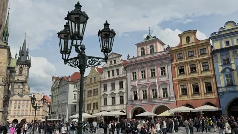 Crowds of visitors gather in Prague Old Town Square among colourful historic Stock Footage 342342211