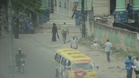 Crowds walk and buses stop to collect passengers in Africa. Stock Footage 85012982