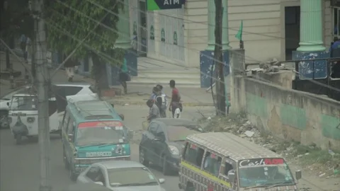 Crowds walk and buses stop to pick up passengers downtown Mombasa. Stock Footage 85012985