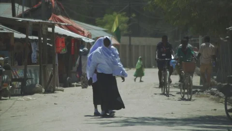 Crowds walk down the streets shopping at village beach town in Nungwi, Zanzibar. Stock Footage 86648148