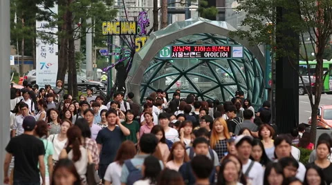 Crowds walk in Seoul's prestigious Gangnam district. Stock Footage
