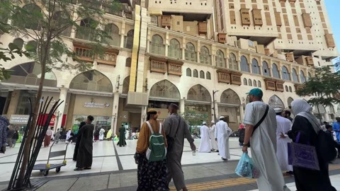 Crowds Walking Around Abraj Al Bait Clock Tower Complex in Mecca, Saudi Arabia Stock Footage 339279293