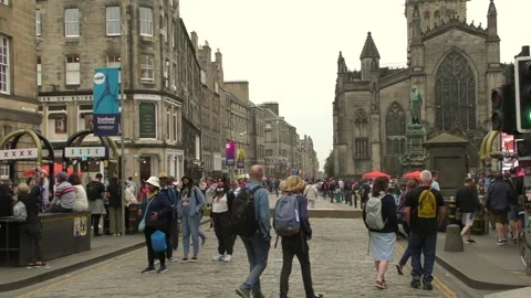 Crowds walking down towards St Giles during festival 2022. Video stock 204156635