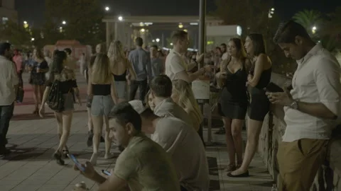 Crowds of Young People Strolling on City Promenade at Night Stock Footage 344604514
