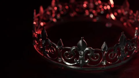 Crown with red dramatic lighting on black background Stock Footage 334562566