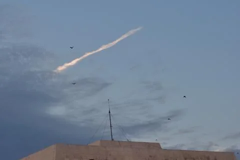 Crows flying on a blue cloudy sky Stock Photos