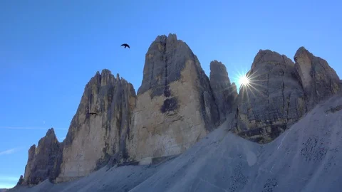 Crows in front of the Three Peaks  of Lavaredo Mountains Stock Footage 128946829