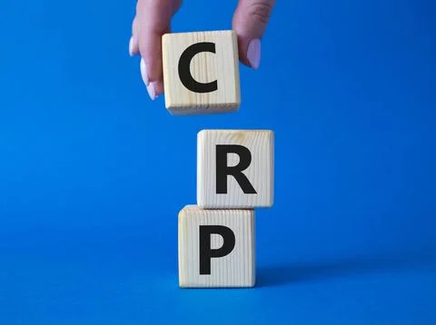 CRP - C-Reactive Protein Test symbol. Wooden cubes with word CRP. Doctor ha.. Stock Photos