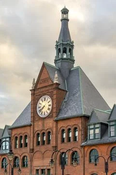 The CRRNJ Terminals red-brick clock tower rises under moody skies. Stock Photos
