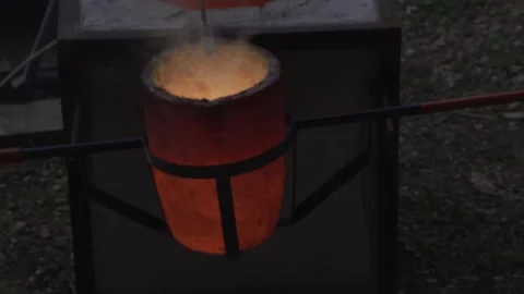 Crucible with molten bronze to the mold Stock Footage 256038115